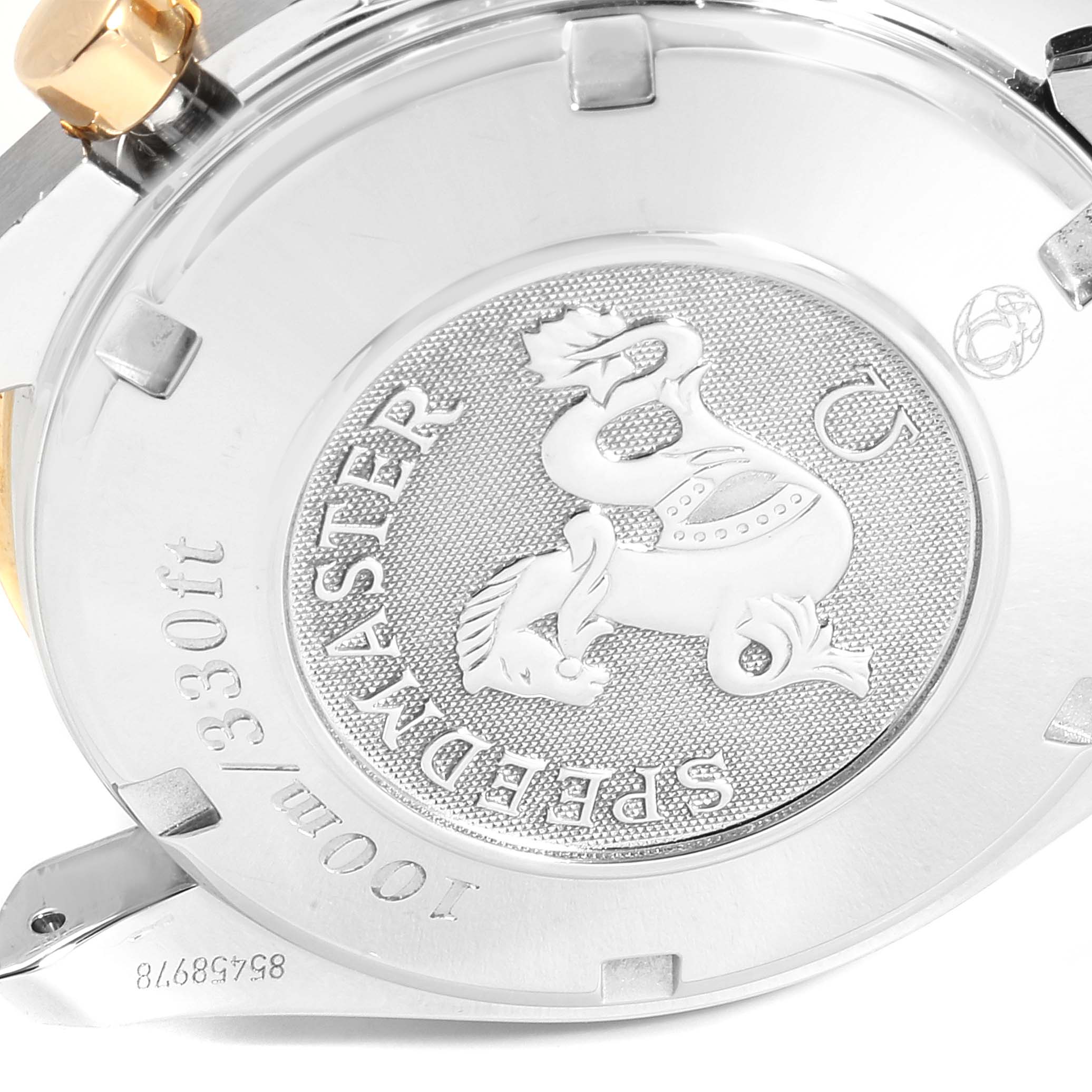 This is a close-up view of the case back of the Omega Speedmaster 323.21.40.44.02.001 Men's Steel and Gold (two tone) Silver Dial 323.21.40.44.02.001 Men's Steel and Gold (two tone) Silver Dial watch, showcasing the engraved logo and details.