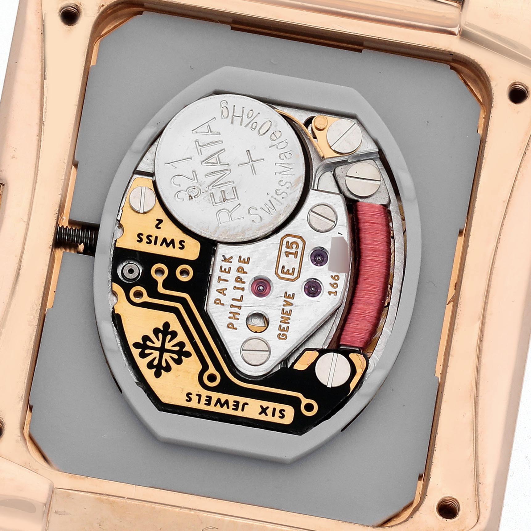 The image shows the movement and battery of a Patek Philippe Twenty-4 4910R Women's Rose Gold Brown Dial 4910R Women's Rose Gold Brown Dial watch from a back perspective.