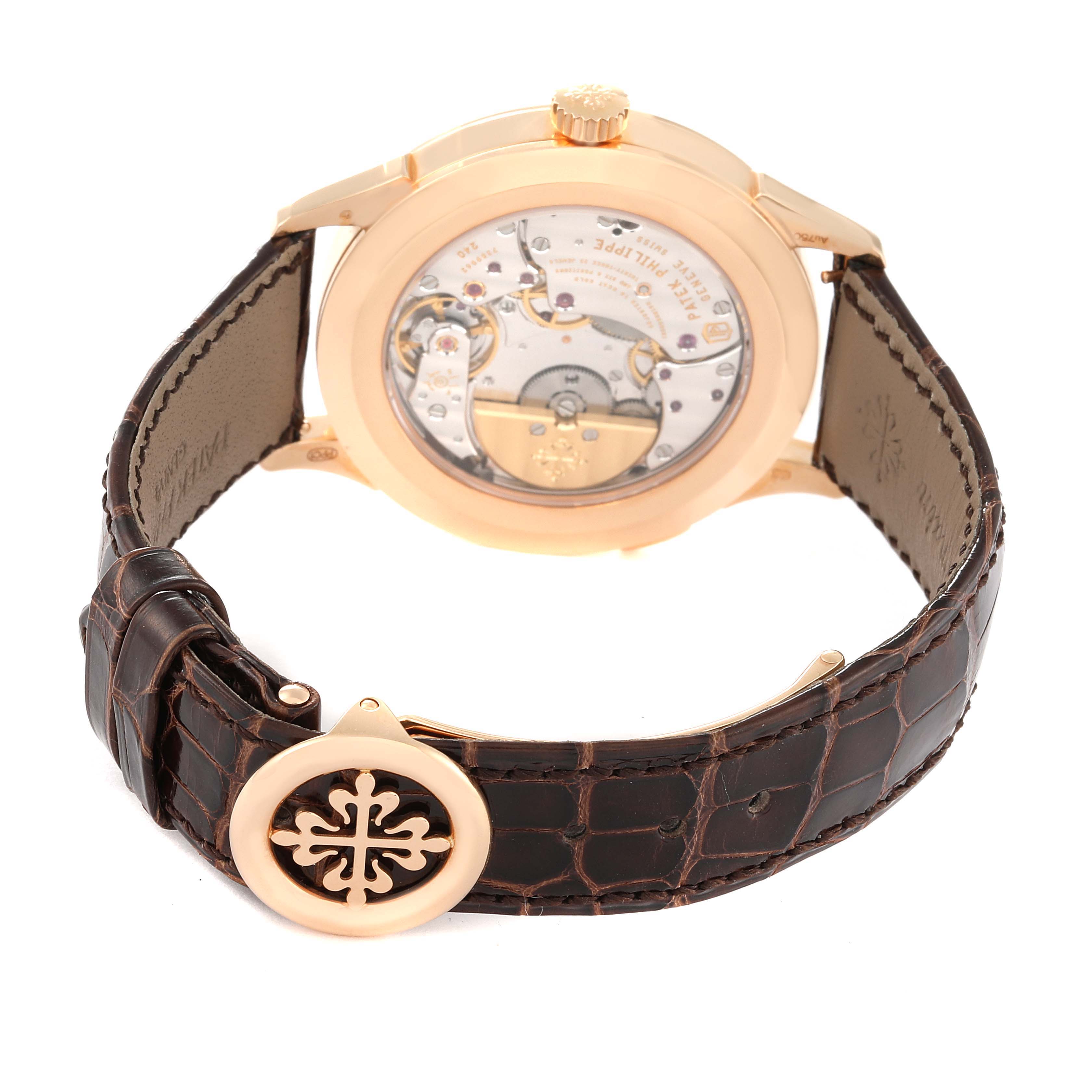 The image shows the back view of a Patek Philippe Complications 5230R Men's Rose Gold Grey Dial 5230R Men's Rose Gold Grey Dial watch, highlighting its movement and leather strap.