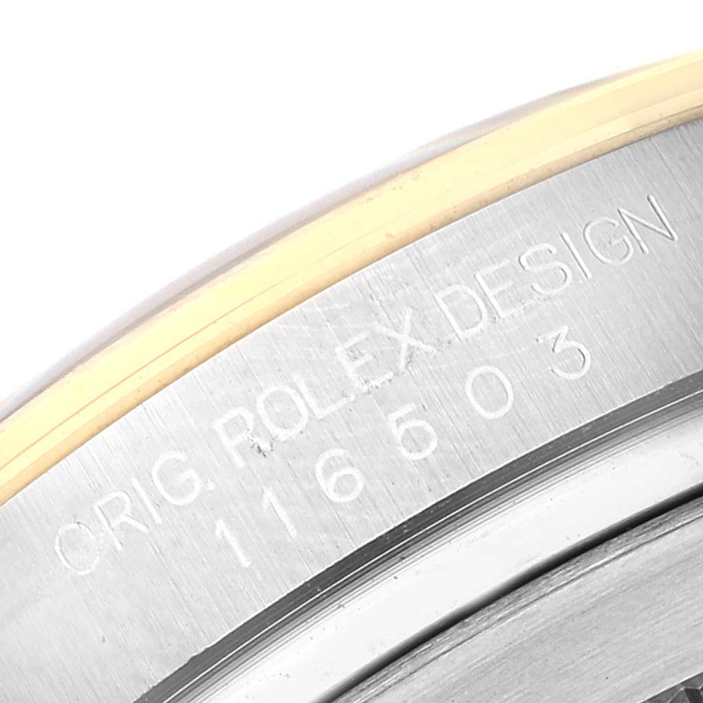 This image shows a close-up of the model number and "Orig. Rolex Design" engraving on the case of a Rolex Daytona 116503 Men
s Steel and Gold (two tone) White Dial 116503 Men
s Steel and Gold (two tone) White Dial watch.