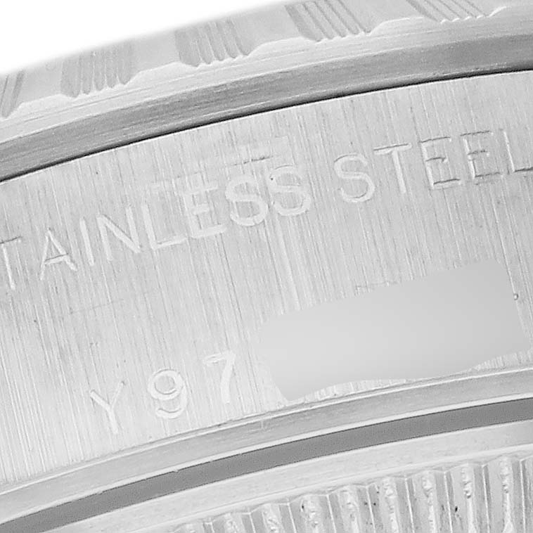 This close-up image shows the engravings on the stainless steel case back of a Rolex Date 79240 Women's Stainless Steel Black Dial 79240 Women's Stainless Steel Black Dial model watch.