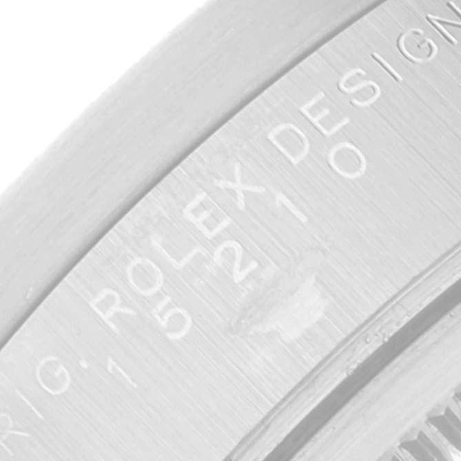 The image shows a close-up angle of the engraved lettering on the side of a Rolex Date 15210 Men
s Stainless Steel Pink Dial 15210 Men
s Stainless Steel Pink Dial model watch
s case.