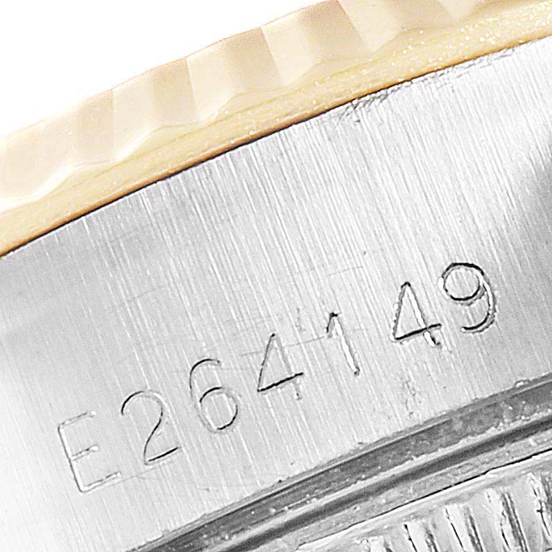 This close-up image of a Rolex Datejust 69173 Women
s Steel and Gold (two tone) Champagne Dial 69173 Women
s Steel and Gold (two tone) Champagne Dial shows the serial number engraved on the side of the watch case and part of the bezel.