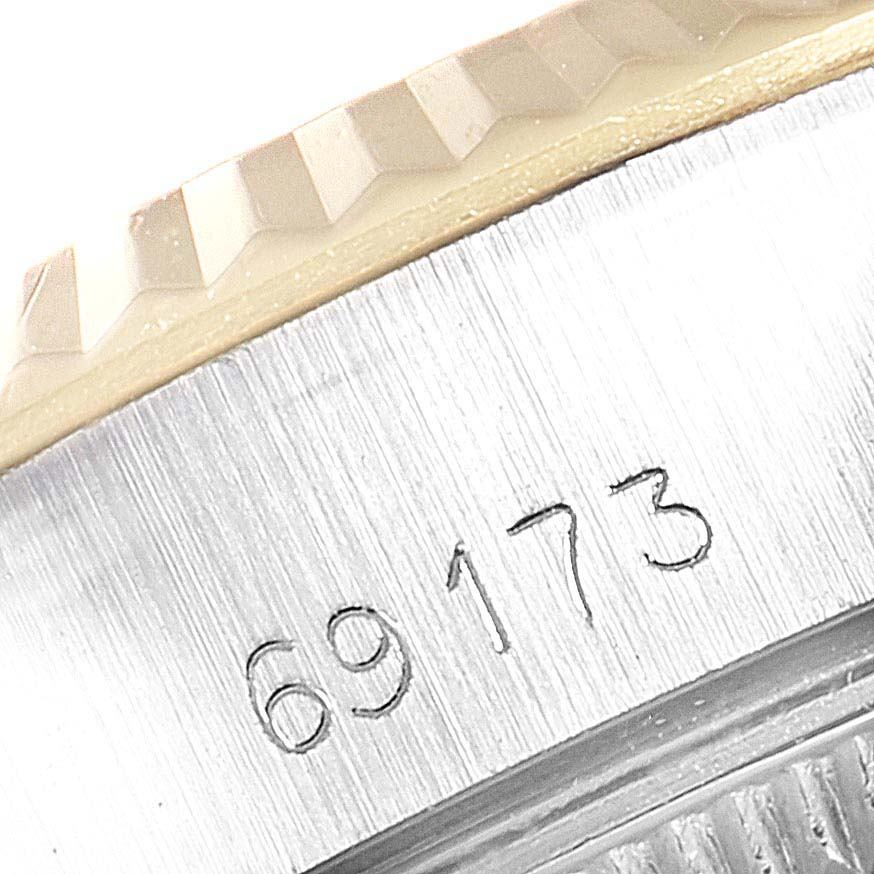 This close-up image shows the fluted bezel and part of the reference number (69173) of a Rolex Datejust 69173 Women
s Steel and Gold (two tone) Champagne Dial 69173 Women
s Steel and Gold (two tone) Champagne Dial watch.