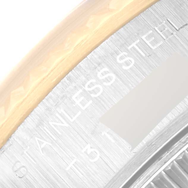 This image shows a close-up view of the edge of the bezel and the "STAINLESS STEEL" engraving on the side of a Rolex Datejust 69173 Women's Steel and Gold (two tone) Black Dial 69173 Women's Steel and Gold (two tone) Black Dial watch.