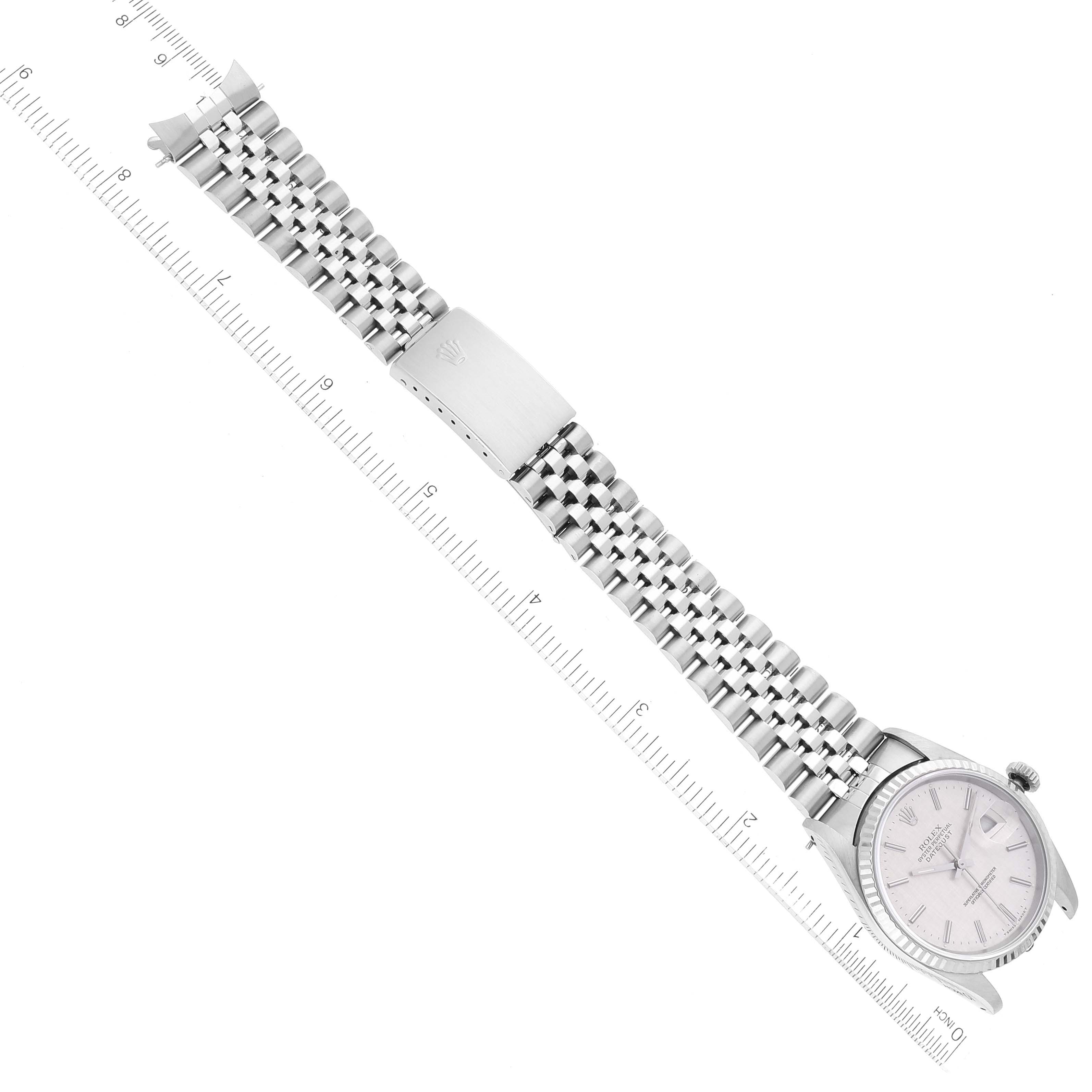 The image shows a Rolex Datejust 16234 Men's Stainless Steel Silver Dial 16234 Men's Stainless Steel Silver Dial watch laid flat, displaying its bracelet and clasp alongside a ruler for measurement.