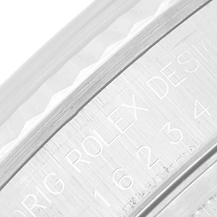 This is a close-up of the inner bezel of a Rolex Datejust 16234 Men's Stainless Steel Silver Dial 16234 Men's Stainless Steel Silver Dial watch, showing part of the model name and design engraving.