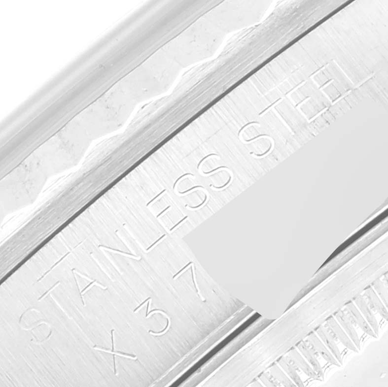 This image shows a close-up of the stainless steel casing with engravings on a Rolex Datejust 16234 Men's Stainless Steel Silver Dial 16234 Men's Stainless Steel Silver Dial watch.