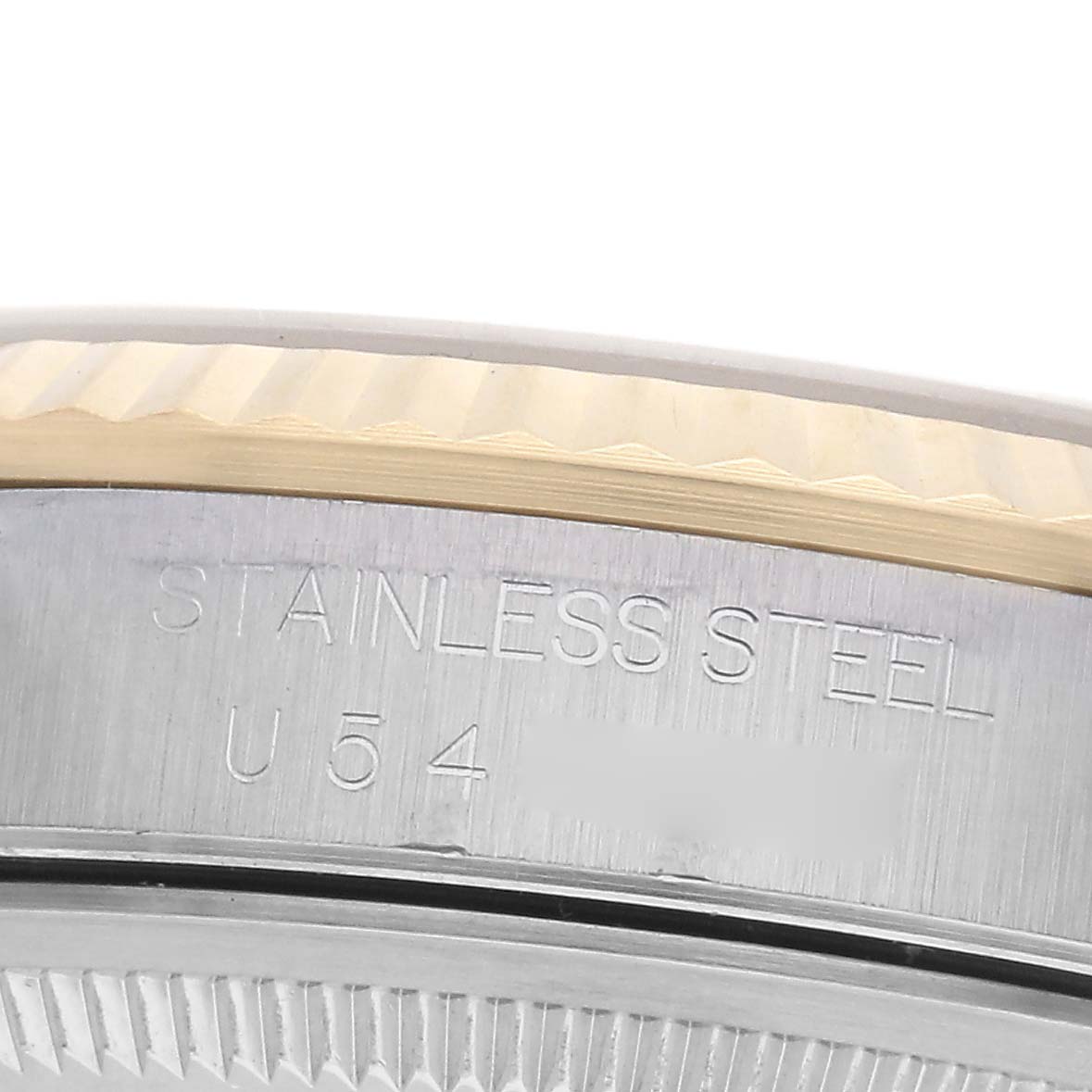 The image shows a close-up of the side of a Rolex Datejust 16233 Men's Steel and Gold (two tone) Blue Dial 16233 Men's Steel and Gold (two tone) Blue Dial, highlighting the stainless steel engraving and fluted bezel edge.