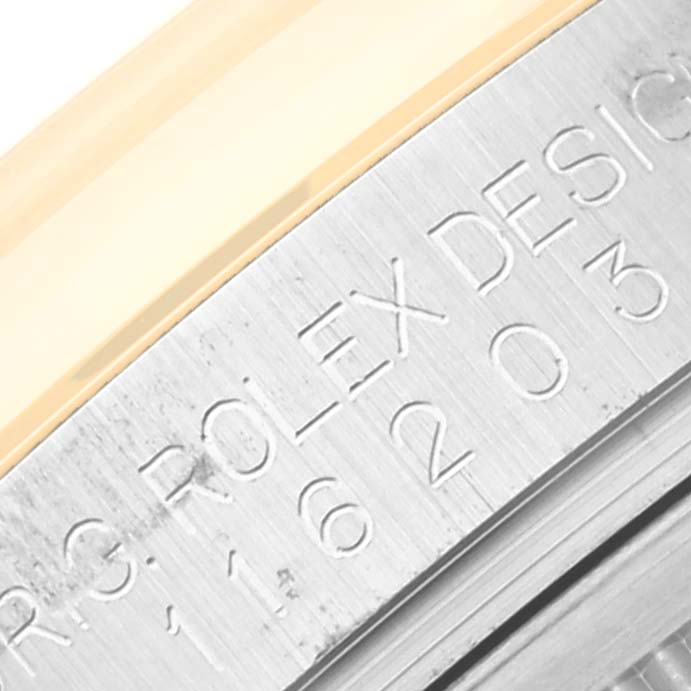 The image shows a close-up of the side engraving on a Rolex Datejust 116203 Men's Steel and Gold (two tone) White Dial 116203 Men's Steel and Gold (two tone) White Dial watch bezel.