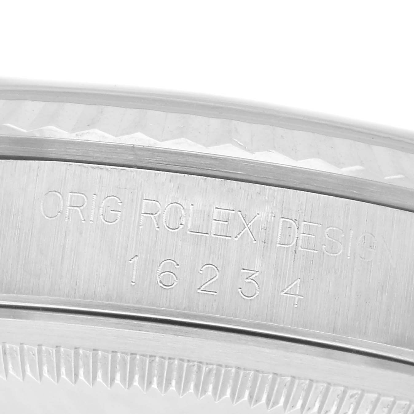 The image shows the side engraving of a Rolex Datejust 16234 Men's Stainless Steel White Dial 16234 Men's Stainless Steel White Dial watch, displaying the model and serial numbers.