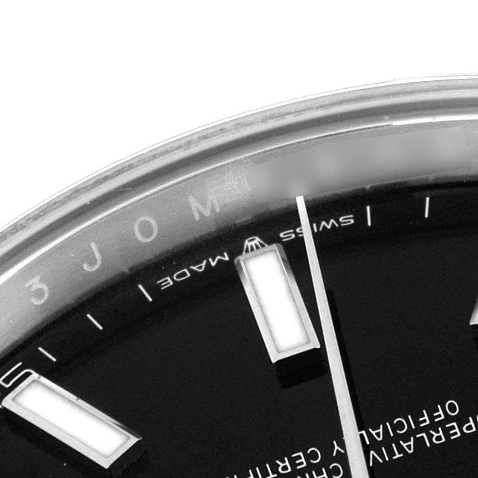 The image shows a close-up of the dial on a Rolex Datejust 41 126300 Men's Stainless Steel Black Dial 126300 Men's Stainless Steel Black Dial, focusing on the upper part with hour markers and text.