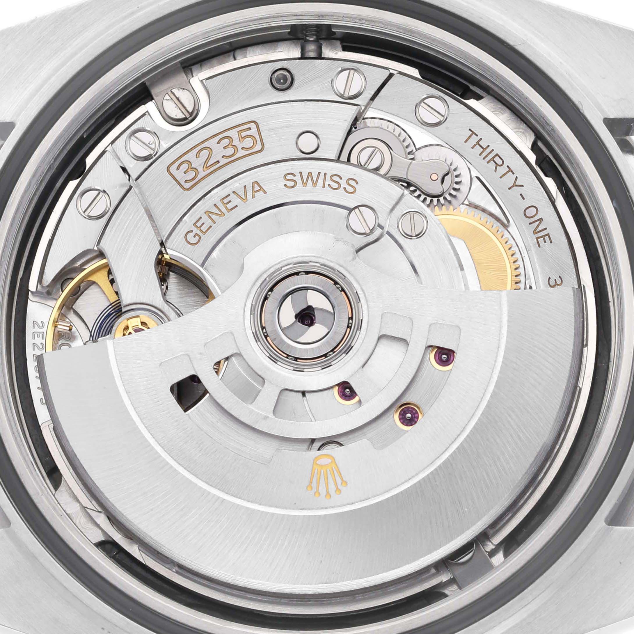 The image shows the Rolex Datejust 41 126300 Men's Stainless Steel Black Dial 126300 Men's Stainless Steel Black Dial's movement from a top-down angle, focusing on its intricate inner mechanisms and gears.