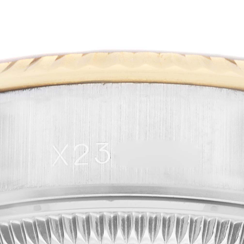 This image shows a close-up of the fluted bezel and serial engraving on a Rolex Datejust 69173 Women's Steel and Gold (two tone) Champagne Dial 69173 Women's Steel and Gold (two tone) Champagne Dial watch.