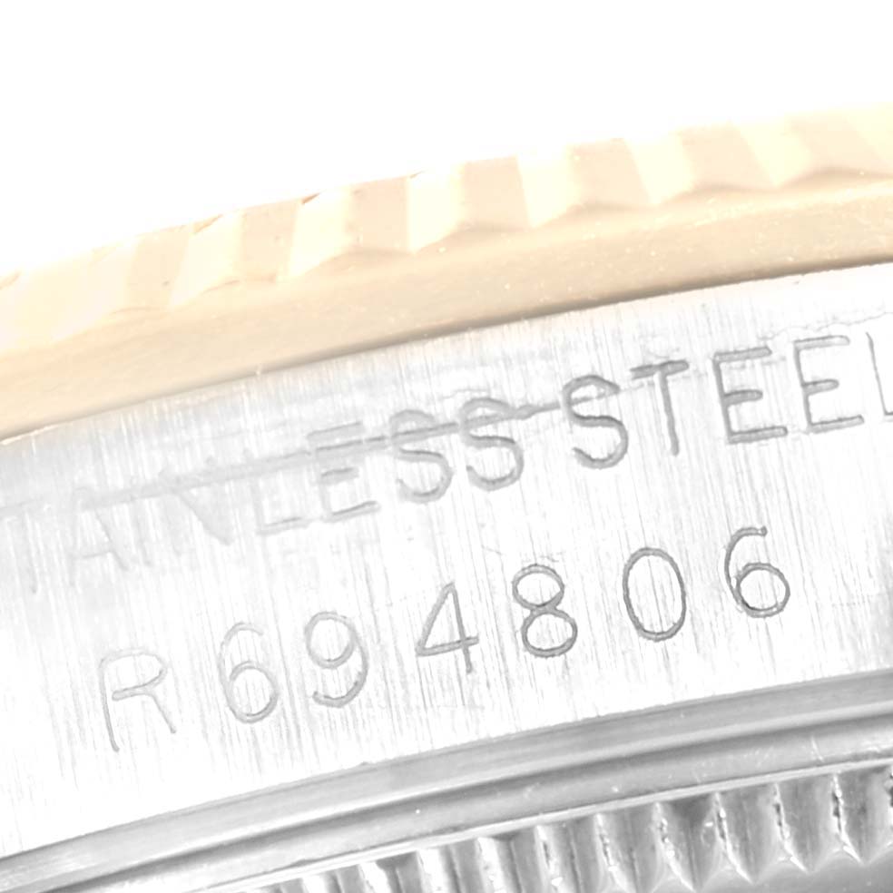 The image shows a close-up of the stainless steel case back with serial number engraving on a Rolex Mid-Size 68273 Women
s Steel and Gold (two tone) White Dial 68273 Women
s Steel and Gold (two tone) White Dial model watch.