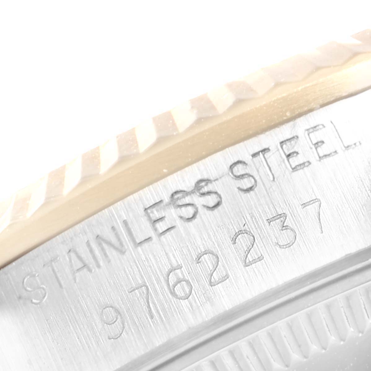 The image shows a close-up of the engraving on the edge of a stainless steel case of a Rolex Mid-Size 68273 Women
s Steel and Gold (two tone) White Dial 68273 Women
s Steel and Gold (two tone) White Dial watch.