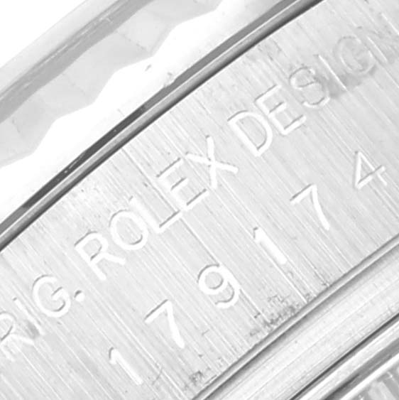 This image shows a close-up of the inner bezel with the engraved serial number of a Rolex Datejust 179174 Women's Stainless Steel Blue Dial 179174 Women's Stainless Steel Blue Dial watch.