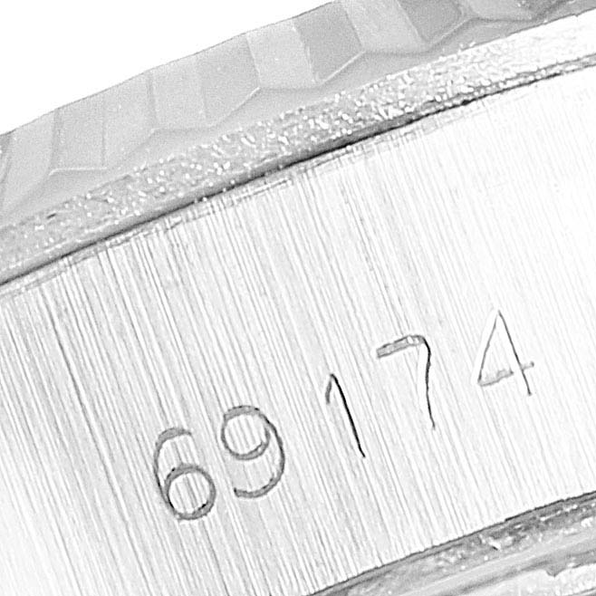 This image shows a close-up of the reference number 69174 engraved on the side of the Rolex Datejust 69174 Women's Stainless Steel Silver Dial 69174 Women's Stainless Steel Silver Dial watch, along with part of the bezel.