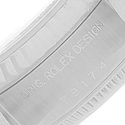 This image shows a close-up angle of the inner case of a Rolex Datejust 79174 Women's Stainless Steel White Dial 79174 Women's Stainless Steel White Dial watch, displaying the engraving "ORIG. ROLEX DESIGN 79174".