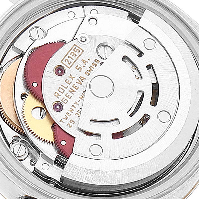 This image shows the intricate internal mechanism of a Rolex Datejust 69173 Women's Steel and Gold (two tone) Grey Dial 69173 Women's Steel and Gold (two tone) Grey Dial watch, featuring gears and the rotor.