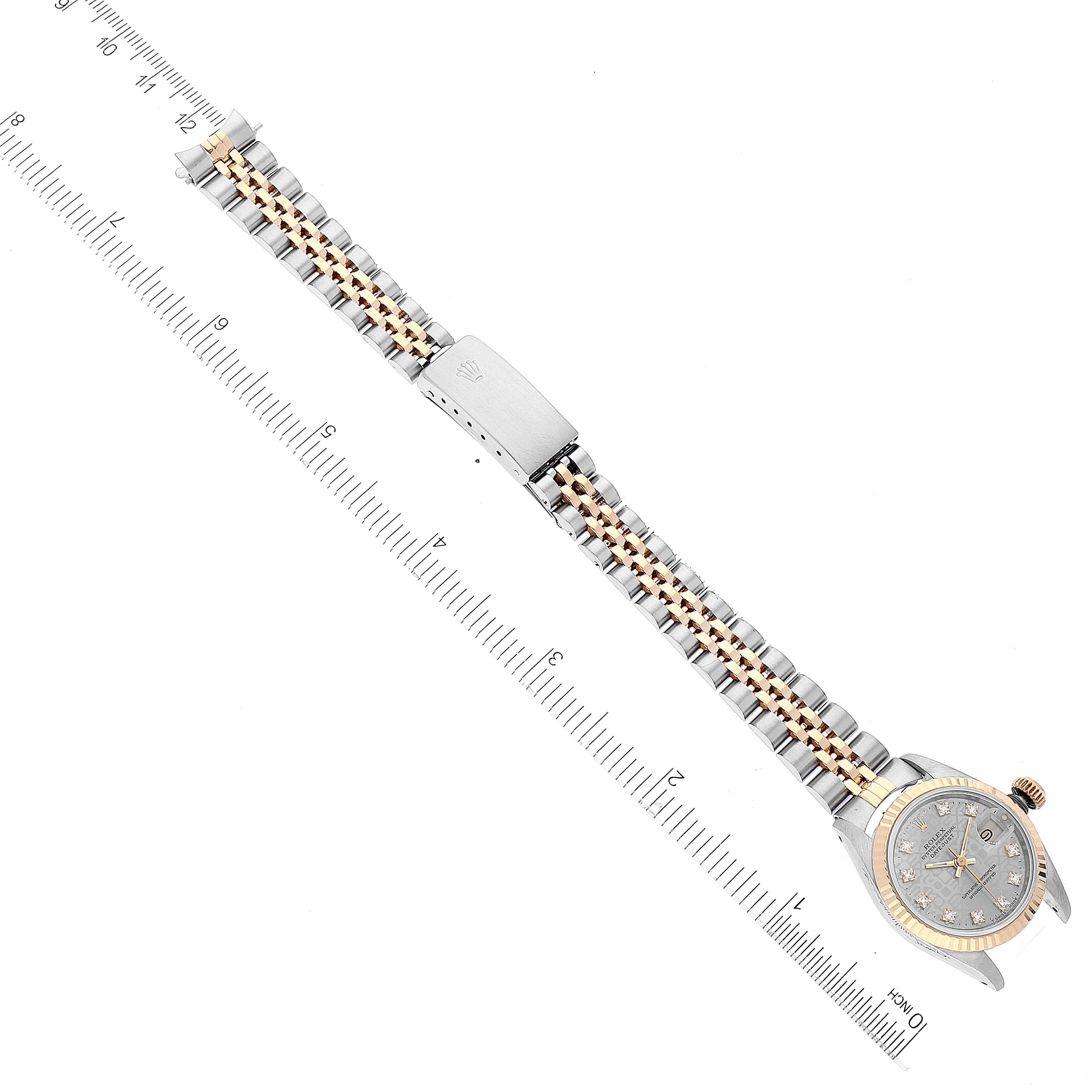 The Rolex Datejust 69173 Women's Steel and Gold (two tone) Grey Dial 69173 Women's Steel and Gold (two tone) Grey Dial wristwatch is shown from an overhead angle, highlighting the bracelet and clasp alongside a ruler for measurement.