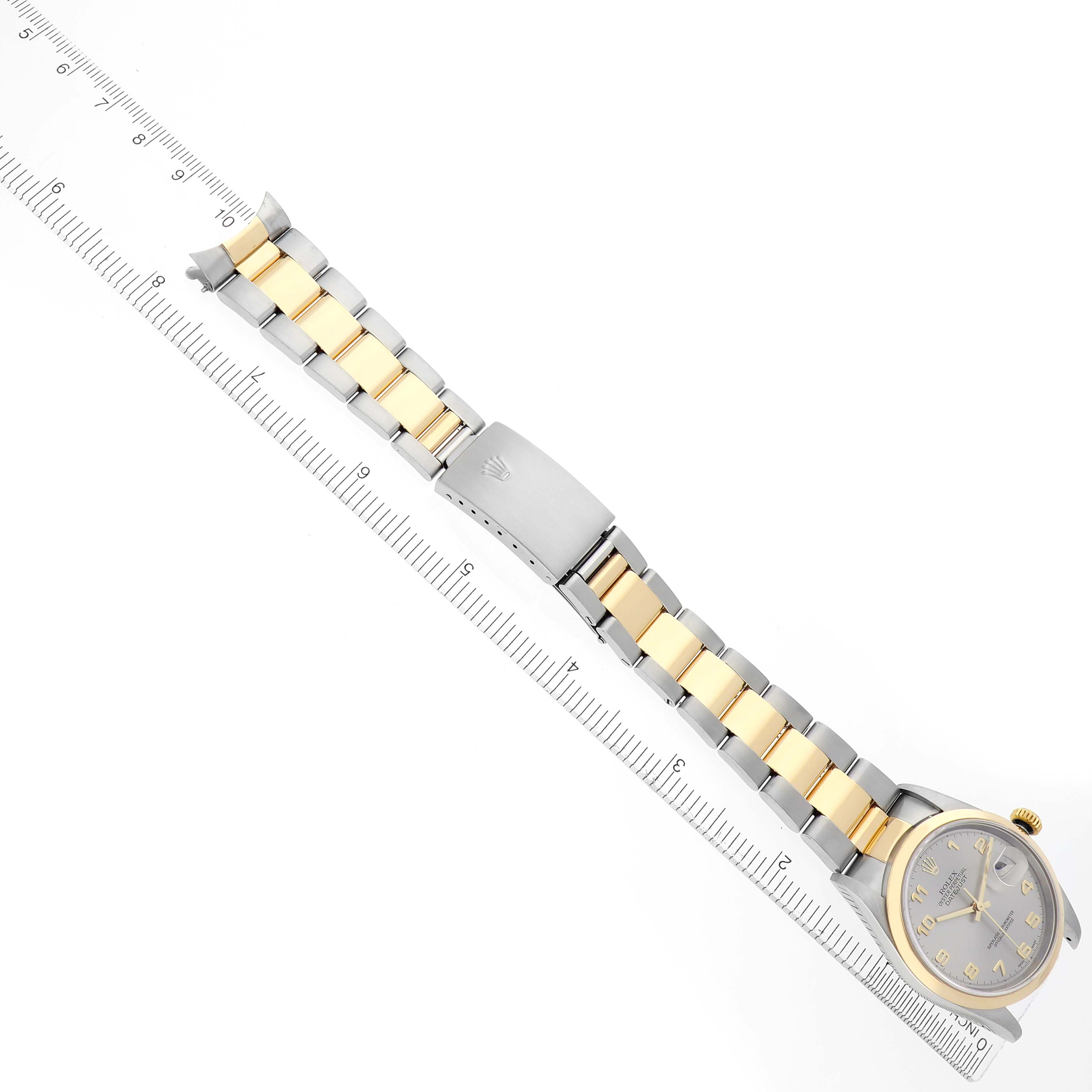 The Rolex Datejust 16203 Men's Steel and Gold (two tone) Grey Dial 16203 Men's Steel and Gold (two tone) Grey Dial watch is shown from above, displaying the full bracelet, clasp, and watch face alongside a ruler for scale.