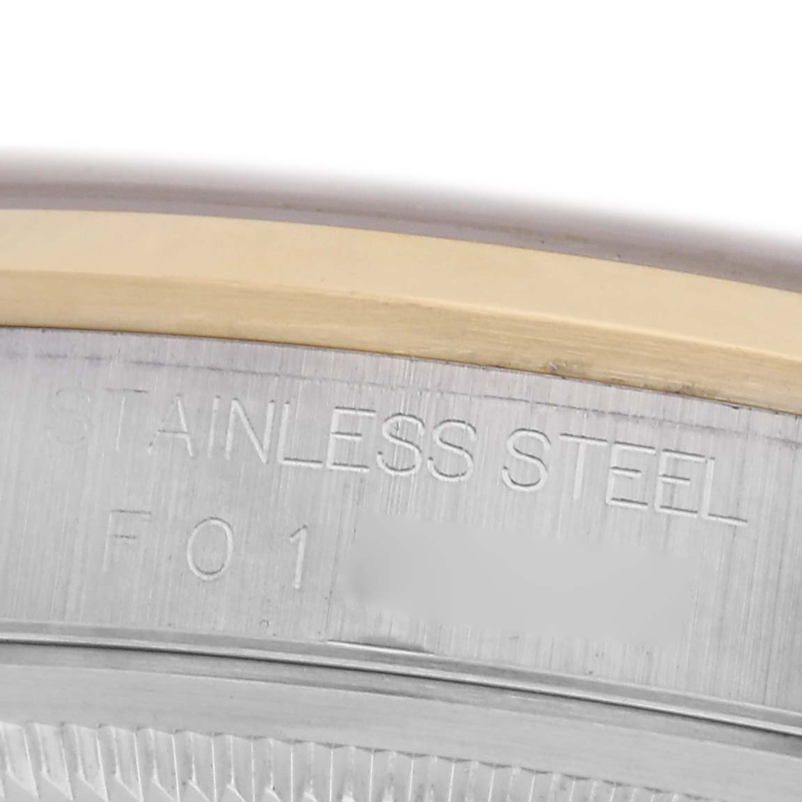 The image shows a close-up of the case edge of a Rolex Datejust 16203 Men's Steel and Gold (two tone) Grey Dial 16203 Men's Steel and Gold (two tone) Grey Dial, highlighting the engraved "STAINLESS STEEL" marking.