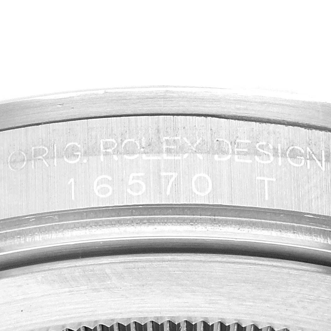 The image shows a close-up of the casing with the engraved serial number of a Rolex Explorer 16570 Men's Stainless Steel Black Dial 16570 Men's Stainless Steel Black Dial watch.