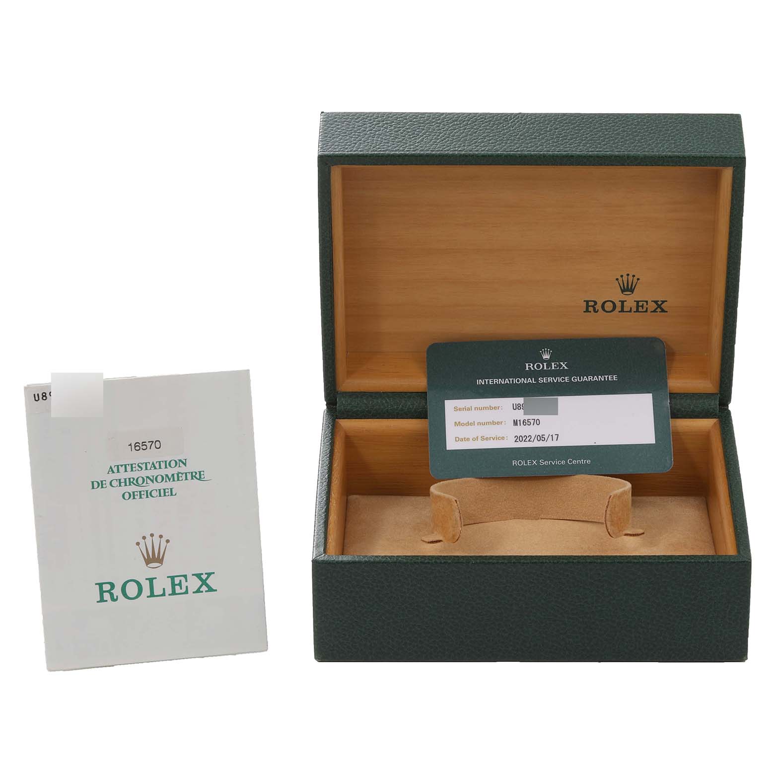 The image shows a Rolex Explorer 16570 Men
s Stainless Steel Black Dial 16570 Men
s Stainless Steel Black Dial model 16570 box, service guarantee card, and official chronometer attestation certificate.