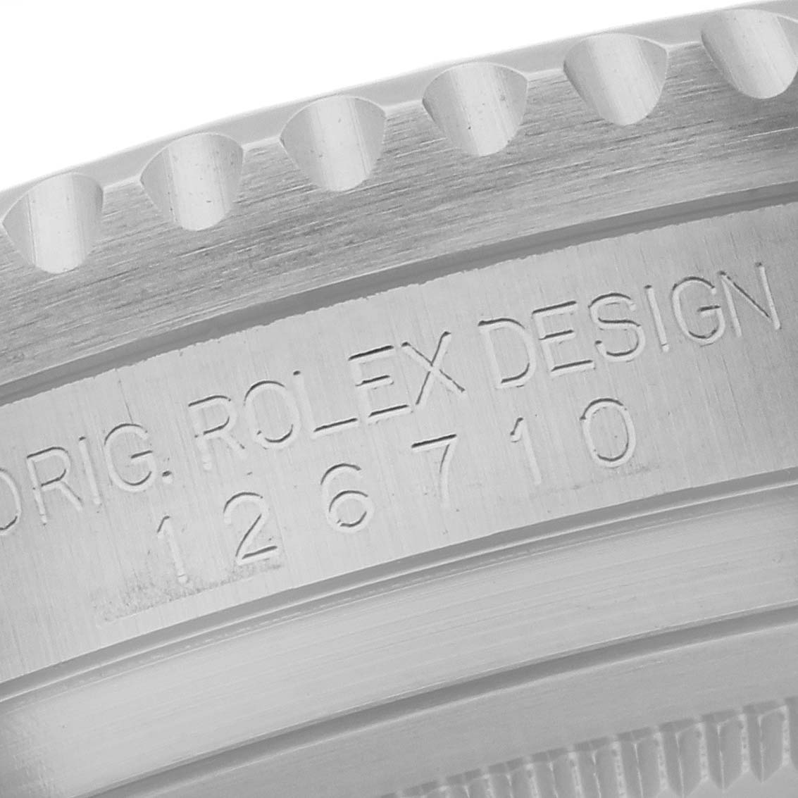 This close-up shows the engraved side of the bezel of a Rolex GMT-Master 126710 Men's Stainless Steel Black Dial 126710 Men's Stainless Steel Black Dial model, featuring the design and model number.