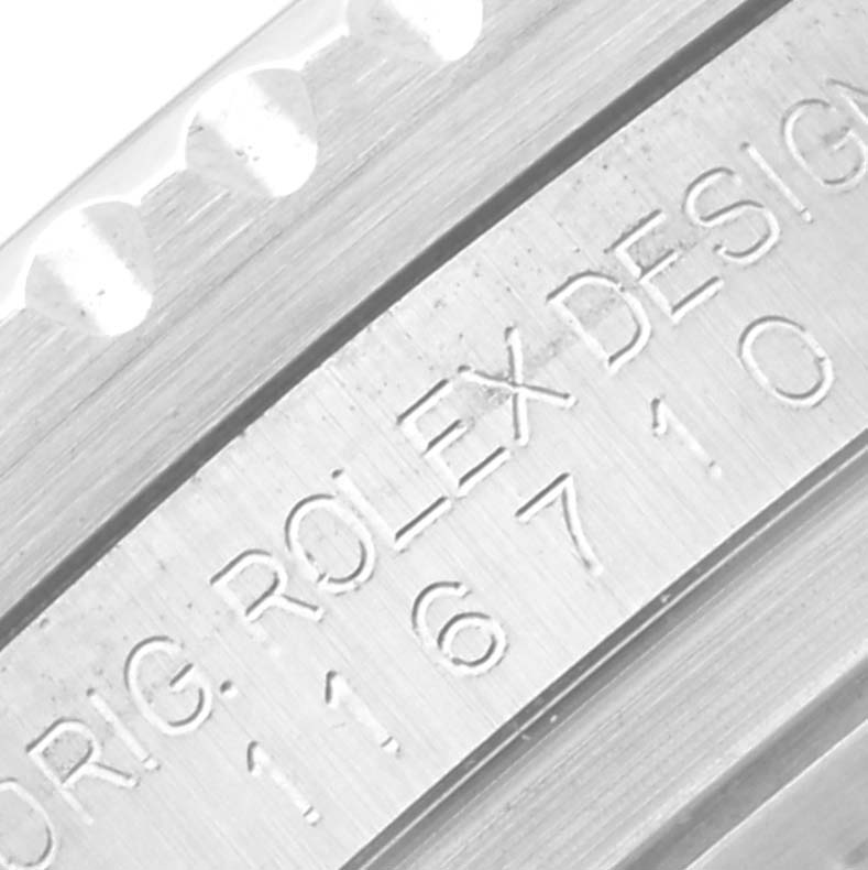 The image shows a close-up of the casing and engraved design numbers on a Rolex GMT-Master 116710 Men
s Stainless Steel Black Dial 116710 Men
s Stainless Steel Black Dial watch.