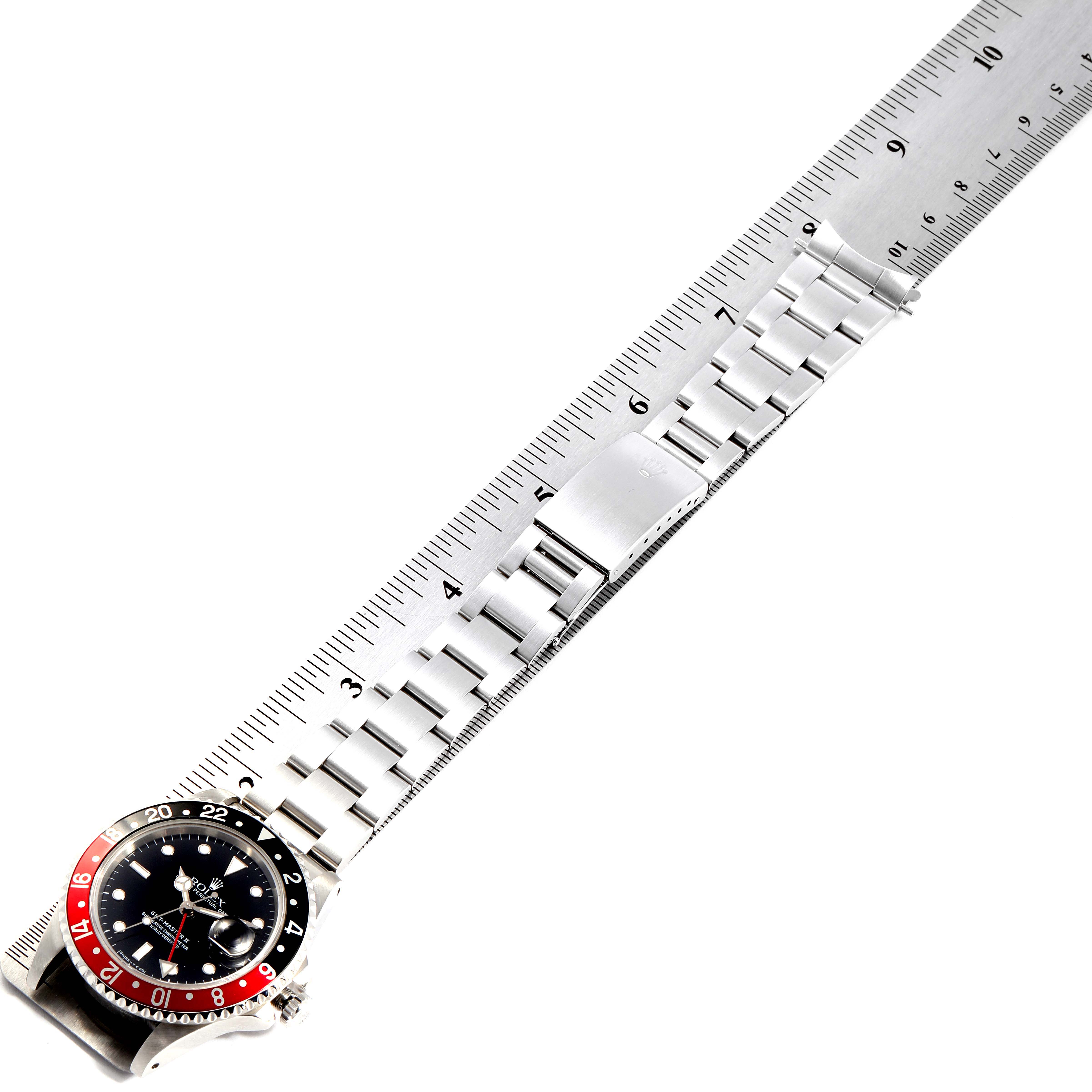 The image shows a top-down view of a Rolex GMT-Master 16710 Men's Stainless Steel Black Dial 16710 Men's Stainless Steel Black Dial watch next to a ruler, with the bracelet and clasp fully extended.