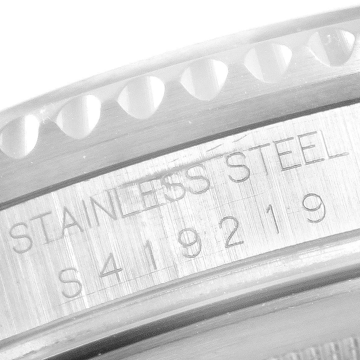 This close-up image shows the engraved serial number and "STAINLESS STEEL" text on the casing of a Rolex GMT-Master 16710 Men's Stainless Steel Black Dial 16710 Men's Stainless Steel Black Dial watch.