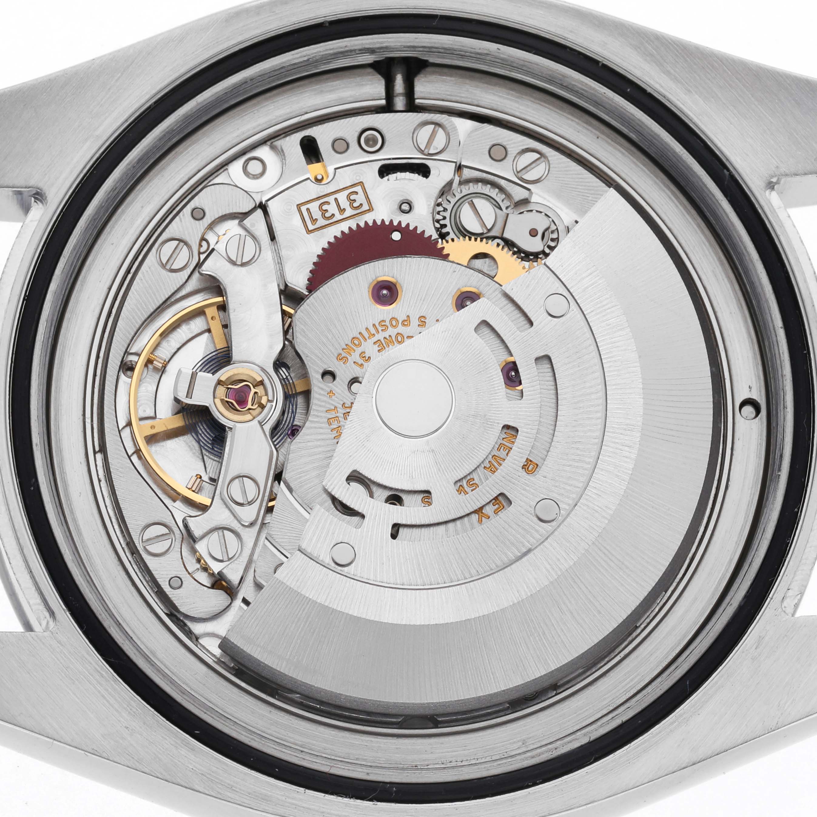 The image shows the movement of a Rolex Milgauss 116400 Men's Stainless Steel White Dial 116400 Men's Stainless Steel White Dial watch from a back angle, highlighting the rotor and intricate mechanical parts.
