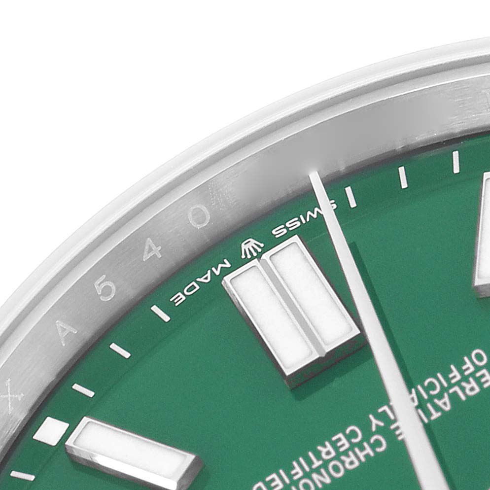 The image shows a close-up of the Rolex Oyster Perpetual 124300 Men's Stainless Steel Green Dial 124300 Men's Stainless Steel Green Dial watch face, highlighting the green dial and hour markers at an angled view.