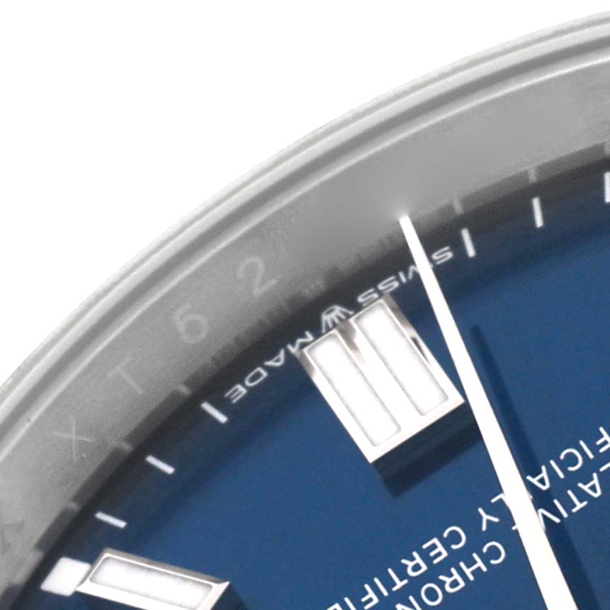 The close-up image shows the dial, a portion of the bezel, and the hour markers of a Rolex Oyster Perpetual 126000 Men
s Stainless Steel Blue Dial 126000 Men
s Stainless Steel Blue Dial watch.