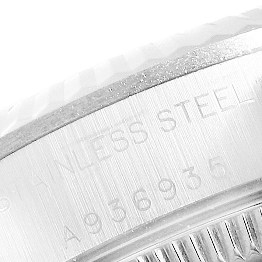 This image shows a close-up of the casing and serial number engraving on a Rolex Oyster Perpetual 76094 Women's Stainless Steel Pink Dial 76094 Women's Stainless Steel Pink Dial watch.