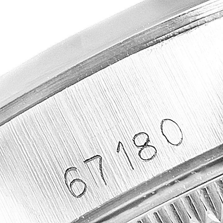 This image shows a close-up of the inside case bearing the serial number 67180 on a Rolex Oyster Perpetual 67180 Women's Stainless Steel Silver Dial 67180 Women's Stainless Steel Silver Dial watch.