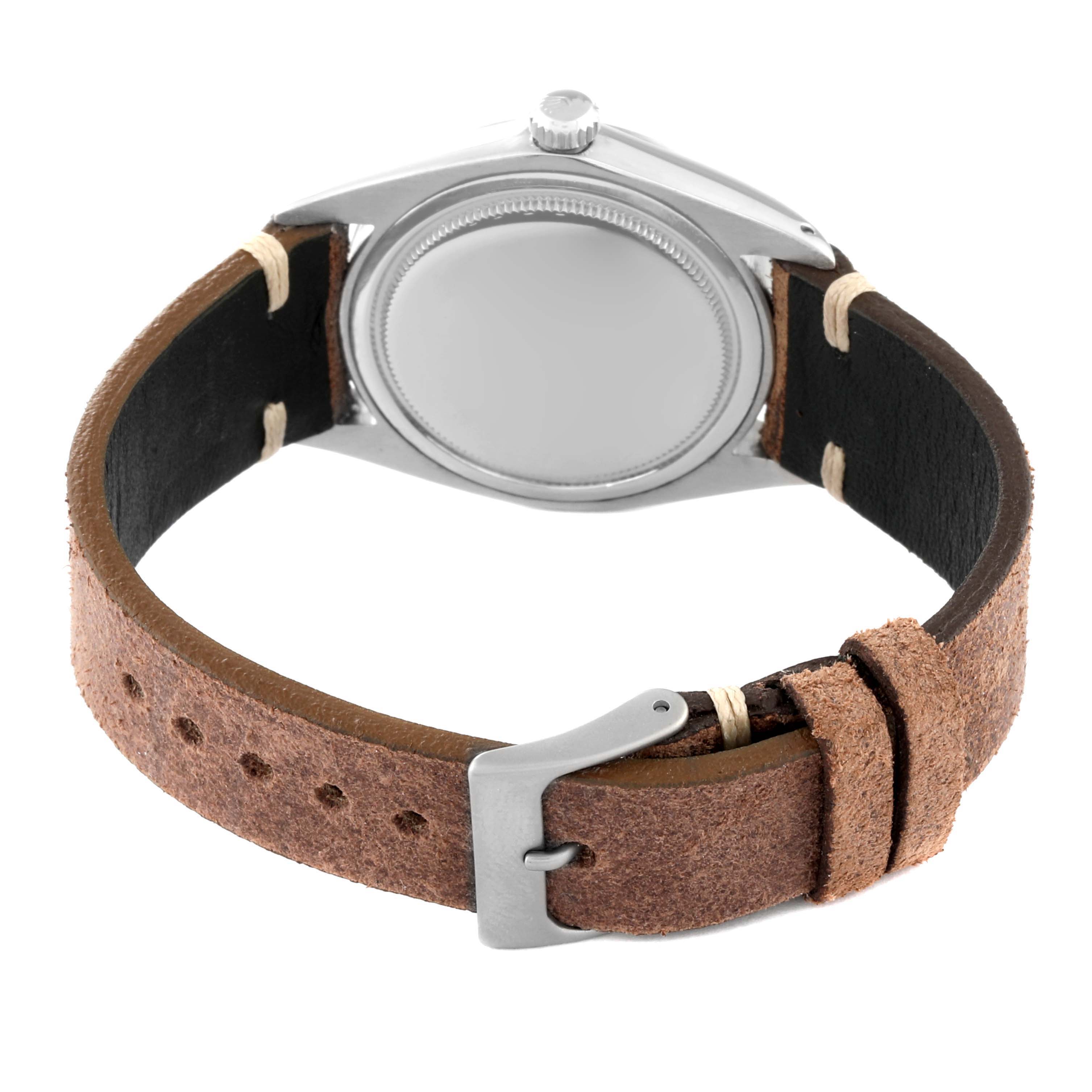 This image shows the back view of a Vintage Collection model by Rolex, highlighting the watch's case, bezel, crown, and leather strap.