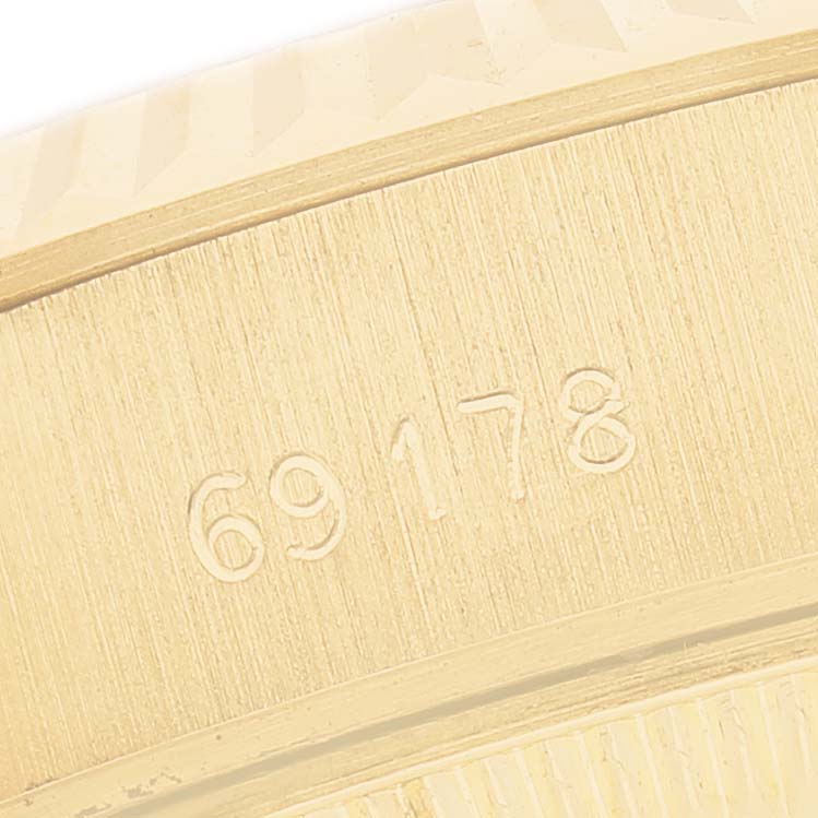 The image shows a close-up of the Rolex President 69178 Women's Yellow Gold Champagne Dial model's case side, displaying its engraved serial number.