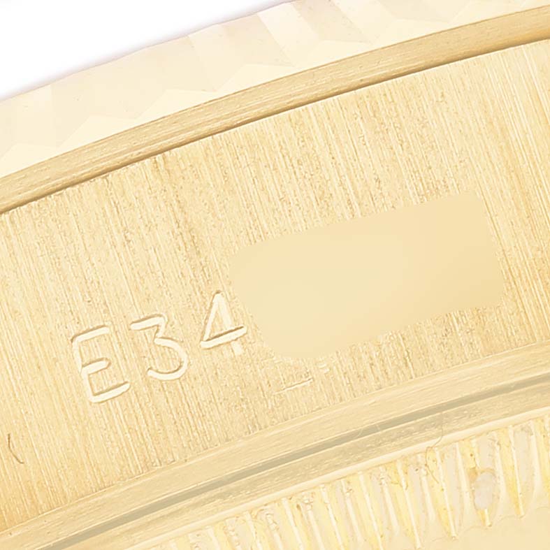 The image shows a close-up of the side of the Rolex President 69178 Women's Yellow Gold Champagne Dial watch, focusing on the engraved serial number.