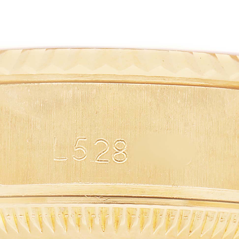 The image shows a close-up side view of the case's engraved serial number on a Rolex President 69178 Women's Yellow Gold Silver Dial model watch.