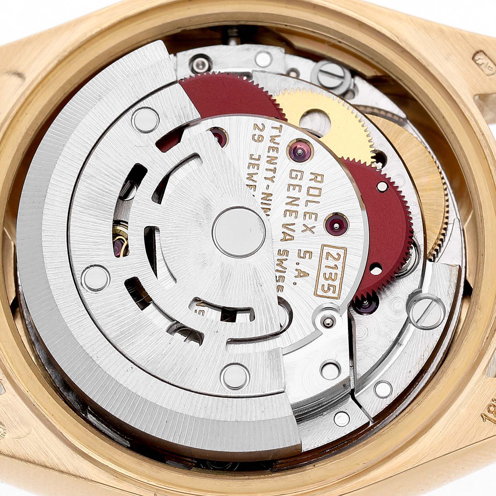 The image shows the movement inside a Rolex President 69178 Women's Yellow Gold Grey Dial watch, including gears and engraving, viewed from the back.