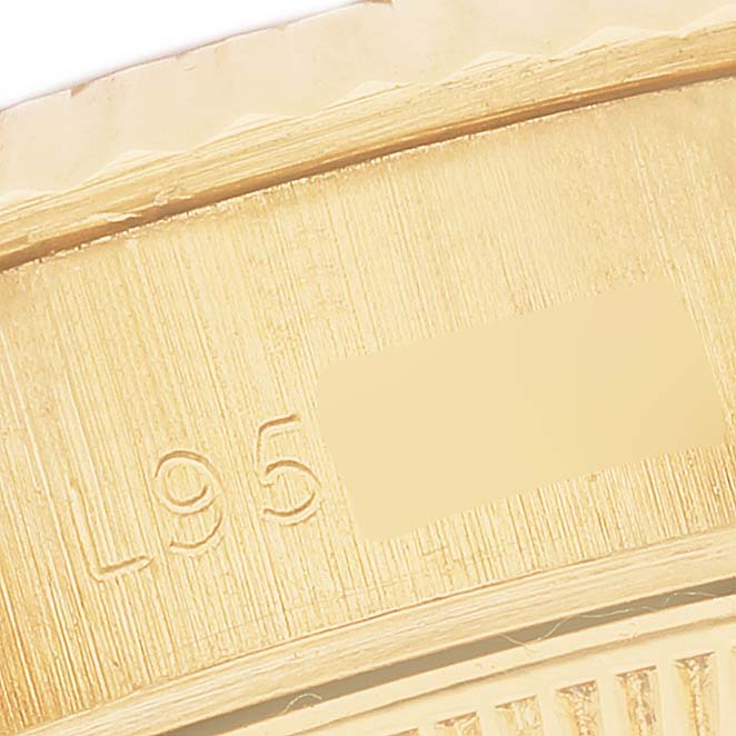 The image shows a close-up of the edge and markings on the Rolex President 69178 Women's Yellow Gold Grey Dial watch's bezel.