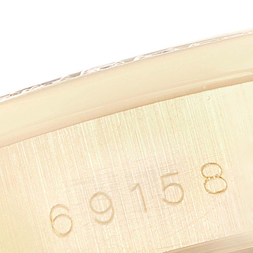 This close-up image shows the model number engraving on the case of the Rolex President 69158 Women
s Yellow Gold Champagne Dial 69158 Women
s Yellow Gold Champagne Dial watch.