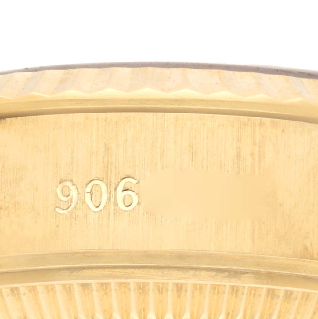 The image shows a close-up of the side of a Rolex President 69178 Women's Yellow Gold Champagne Dial 69178 Women's Yellow Gold Champagne Dial watch, highlighting the case edge and some engraved numbers.