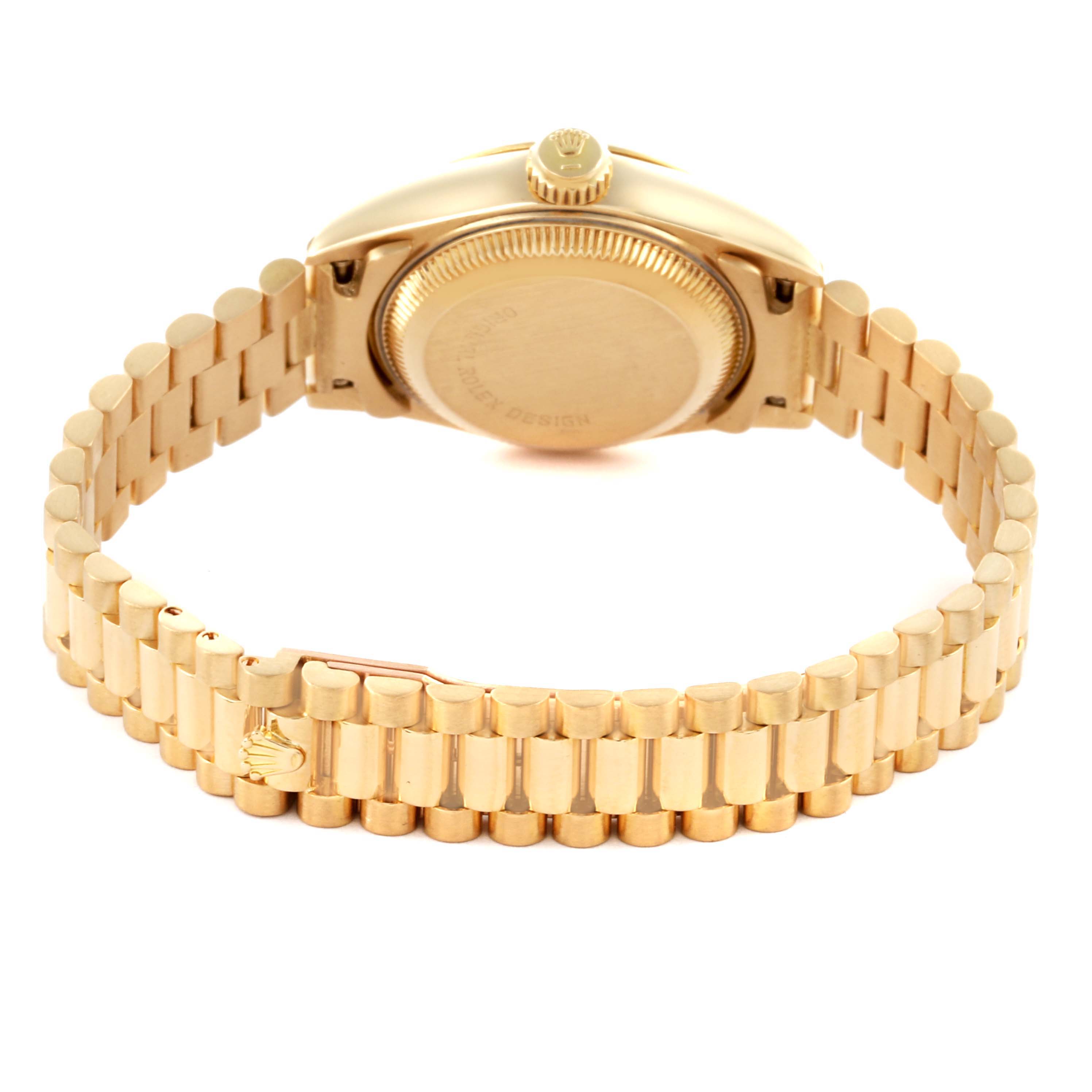 The image shows the backside of a Rolex President 69178 Women's Yellow Gold Champagne Dial 69178 Women's Yellow Gold Champagne Dial model watch, focusing on the case back, crown, and bracelet.