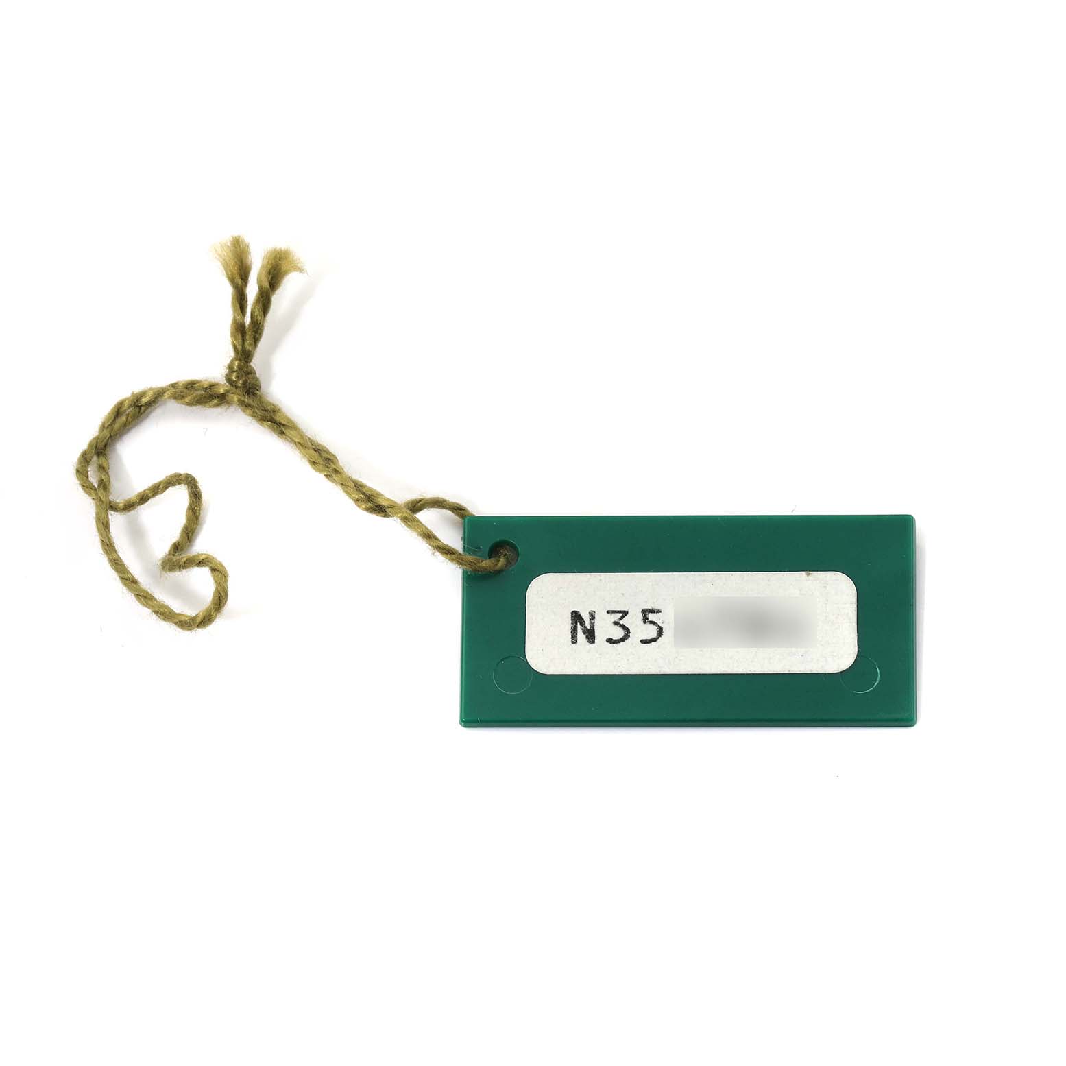 This image shows a green tag with a string, likely an accessory for a Rolex President 69158 Women's Yellow Gold White Dial 69158 Women's Yellow Gold White Dial model watch.