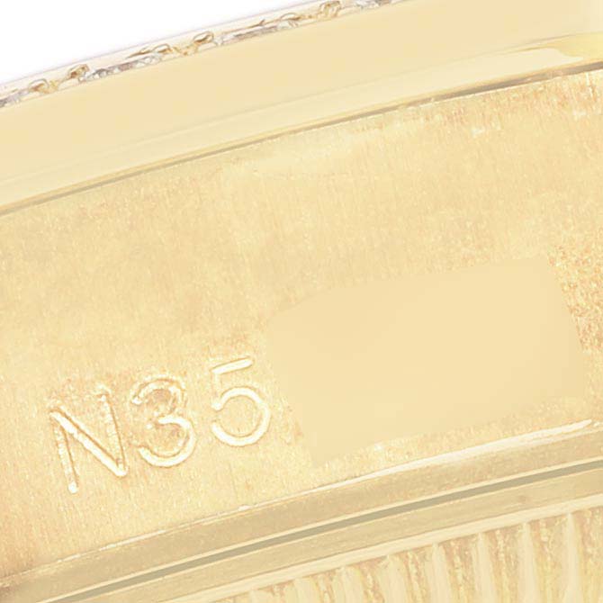 The image shows a close-up of the engraved serial number inside the bezel of a Rolex President 69158 Women's Yellow Gold White Dial 69158 Women's Yellow Gold White Dial model watch.