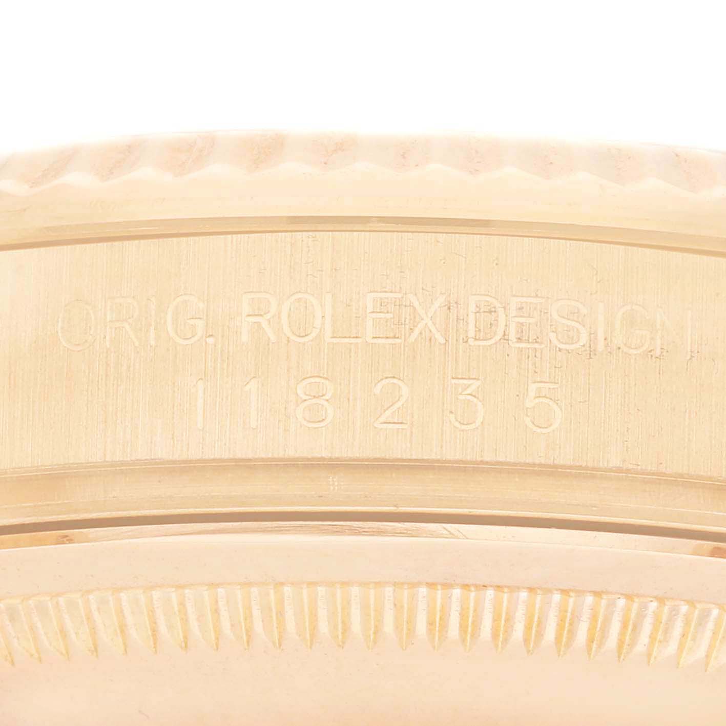 The image shows the side of a Rolex President 118235 Men's Rose Gold Black Dial 118235 Men's Rose Gold Black Dial watch, focusing on the engraved model number and design details.